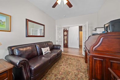 Living room with ceiling fan and wood finished flo