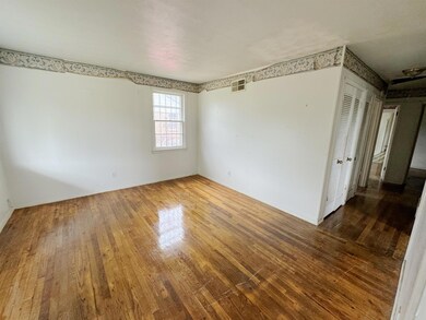 Unfurnished room featuring hardwood / wood-style f