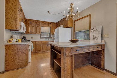 Kitchen with multiple windows and large breakfast bar/island