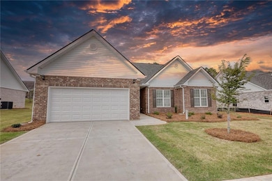 Ranch-style house with central AC unit, a garage, 