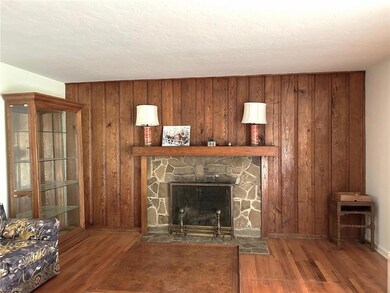 Spacious Living Room with stone fireplace, hardwoo