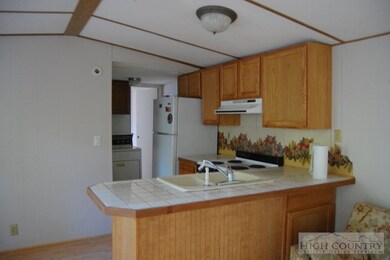 Kitchen: Small galley kitchen has ceramic tile cou