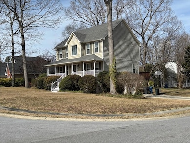 House featuring a porch and a front yard.