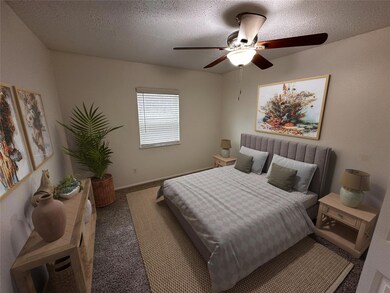 Carpeted bedroom with a ceiling fan, baseboards, a
