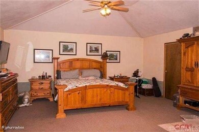 Large master bedroom with cathedral ceilings. Wood