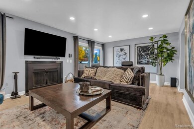 Living area featuring recessed lighting, light wood finished floors, and a fireplace