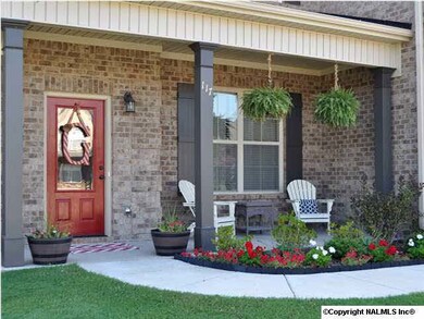 BEAUTIFUL COVERED PORCH ACCENTS THE FRONT ENTRYWAY