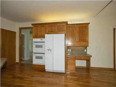 Kitchen has desk and double ovens