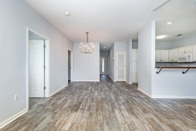 Unfurnished living room featuring wood-type floori