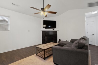Living room with a ceiling fan, vaulted ceiling, w