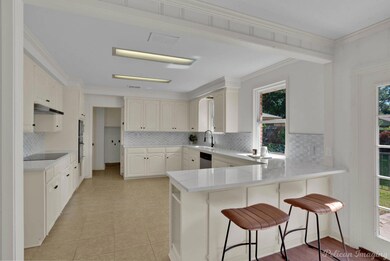 Kitchen with tasteful backsplash, kitchen peninsul