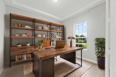 A private study through double glass doors adds a