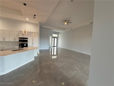 Kitchen featuring pendant lighting, ceiling fan, a