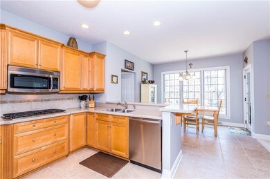 FULLY EQUIPPED KITCHEN HAS STAINLESS APPLIANCES AN