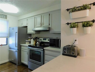 Kitchen has upgraded quartz countertops.