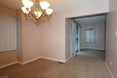 View into living room from dining.  Please notice sliding glass door exit (on left) to wraparound deck.