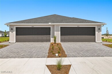 Garage featuring decorative driveway
