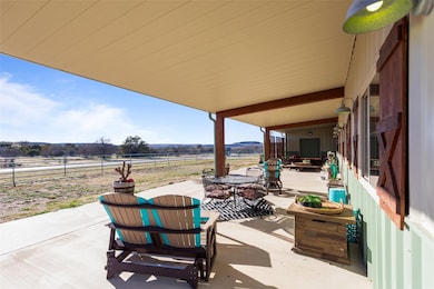 View of patio with outdoor dining space and fence