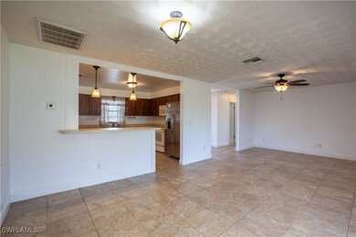 Unfurnished living room with a ceiling fan and bas
