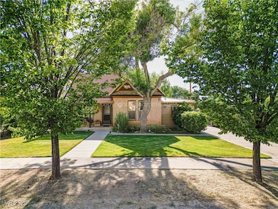 View of front facade featuring a front lawn and brick siding