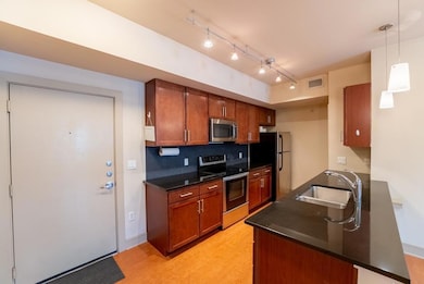 Kitchen with visible vents, a sink, dark countert