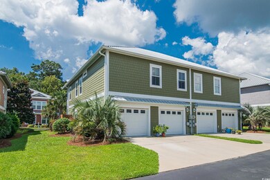 View of front of home with a garage and a front ya