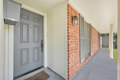 Welcoming brick-front entryway and porch that create a warm first impression.
