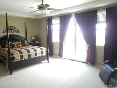 Master bedroom with balcony that overlooks city li