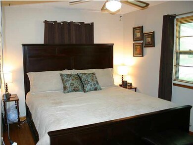The master bedroom has oak floors.