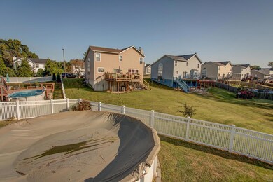 Large fenced backyard with above ground pool.