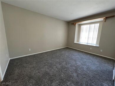 Unfurnished room featuring dark colored carpet and