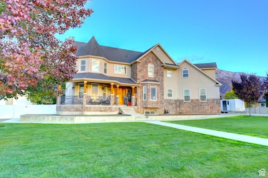 View of front of home featuring covered porch, stone siding, stucco siding, and a mountain view