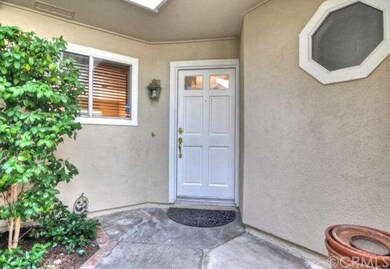 Beautiful gated entryway with planters on either s