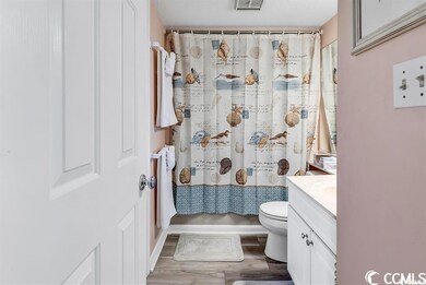 Full bathroom with toilet, vanity, hardwood / wood