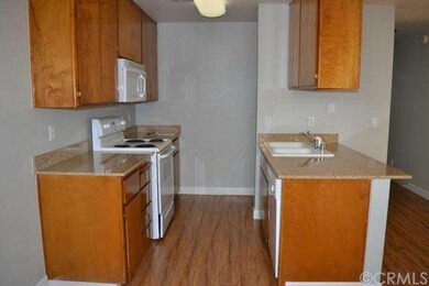 Kitchen Features Granite Counters and Wood Laminat