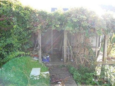 Other. Pergola roof covers side entrance to utilit