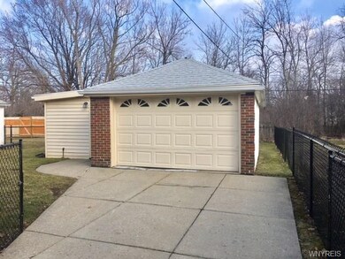 Detached garage with additional attached shed