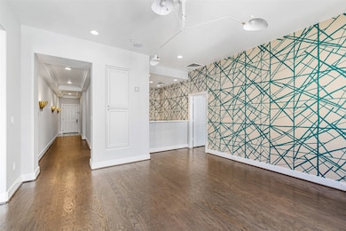 View of formal entry with sconce lighting.