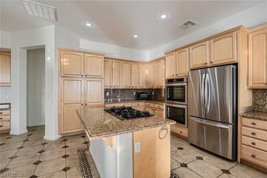 With Stainless Appliances, Island Seating & an Arr