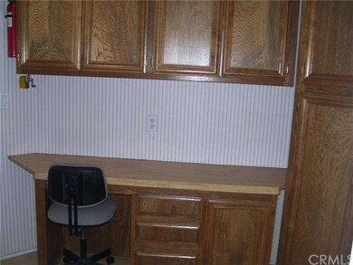 the other side of the laundry room with desk and s