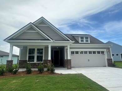 Craftsman-style home with a front yard and covered