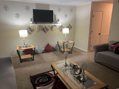 Carpeted living room with crown molding and a text