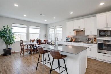 Kitchen featuring oven, built in microwave, a cen