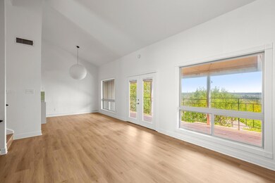 Open concept, updated flooring, high vaulted ceilings, and plenty of natural light throughout