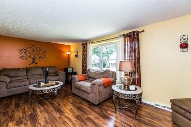 New Pergo flooring gives the living room a warm am