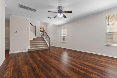 Unfurnished living room featuring stairs, dark wo