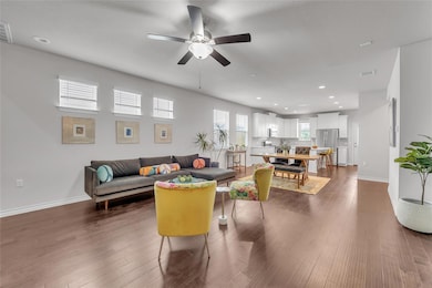 Living room with recessed lighting, baseboards, a