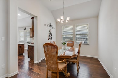 Dining area featuring dark wood-style flooring, a