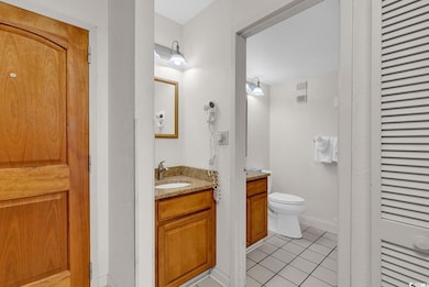 Bathroom featuring tile patterned flooring, toilet