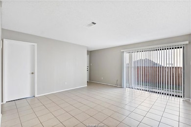 Spare room featuring a textured ceiling and light